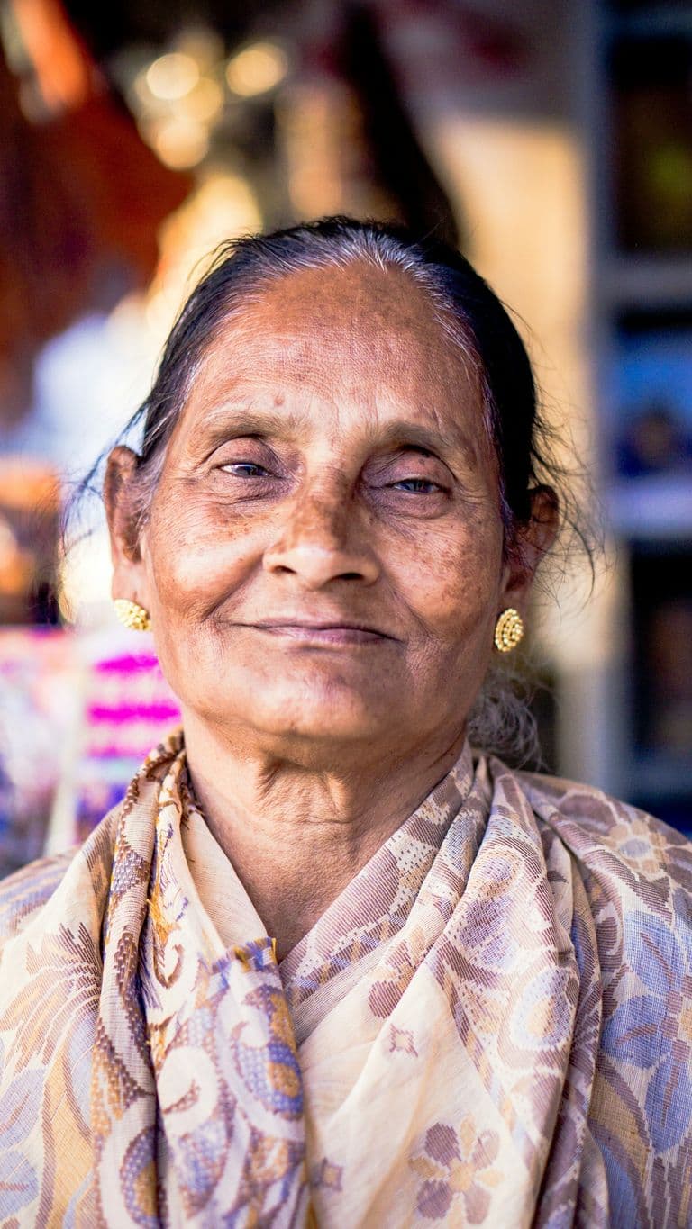 A smiling older woman in soft daylight
